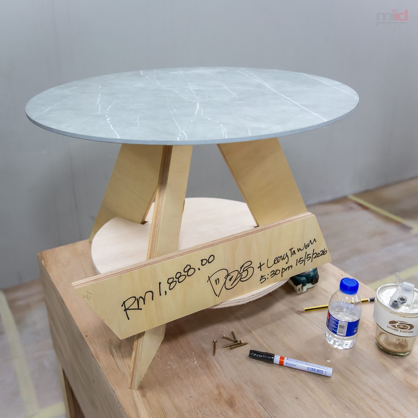 A finished side table pairing a marble top with a timber base